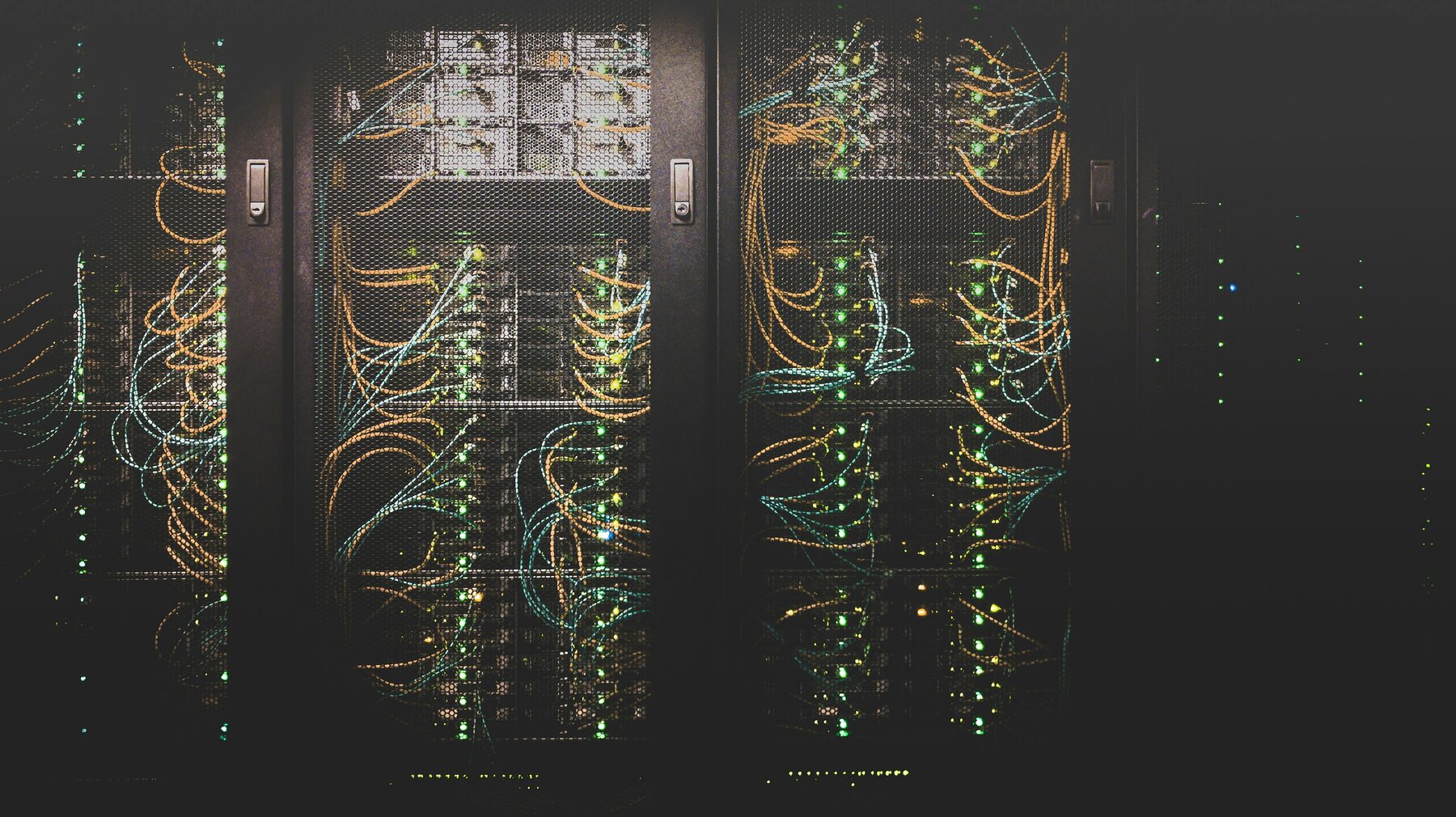 Physical data-center racks and network cabling used as a real infrastructure reference